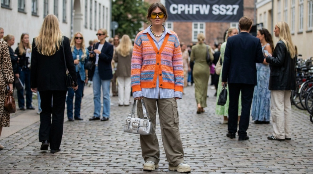 Street style look featuring colourful knitwear and statement accessories at Copenhagen Fashion Week SS27