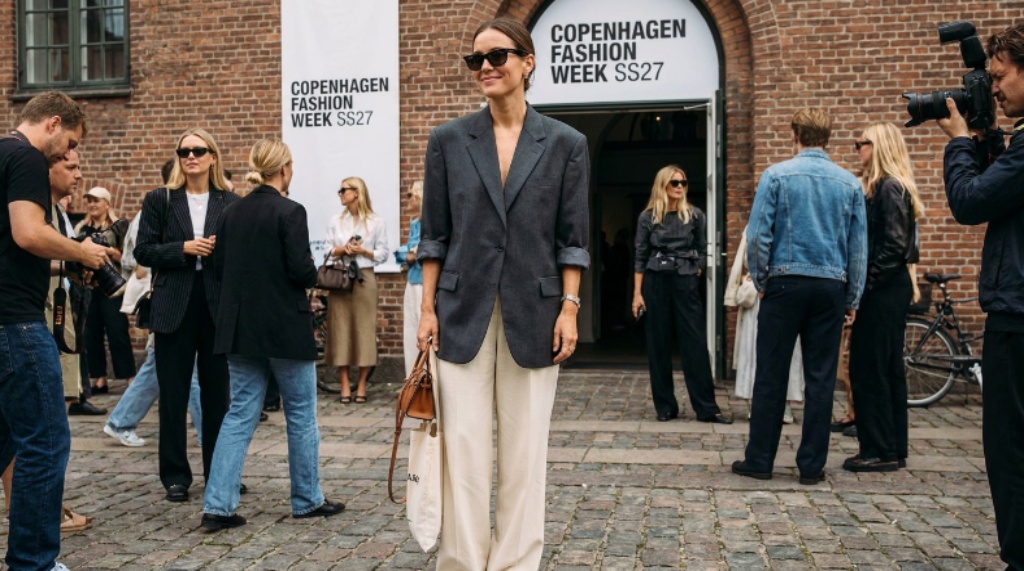 Fashion attendee wearing an oversized blazer and wide-leg trousers outside Copenhagen Fashion Week SS27 venue
