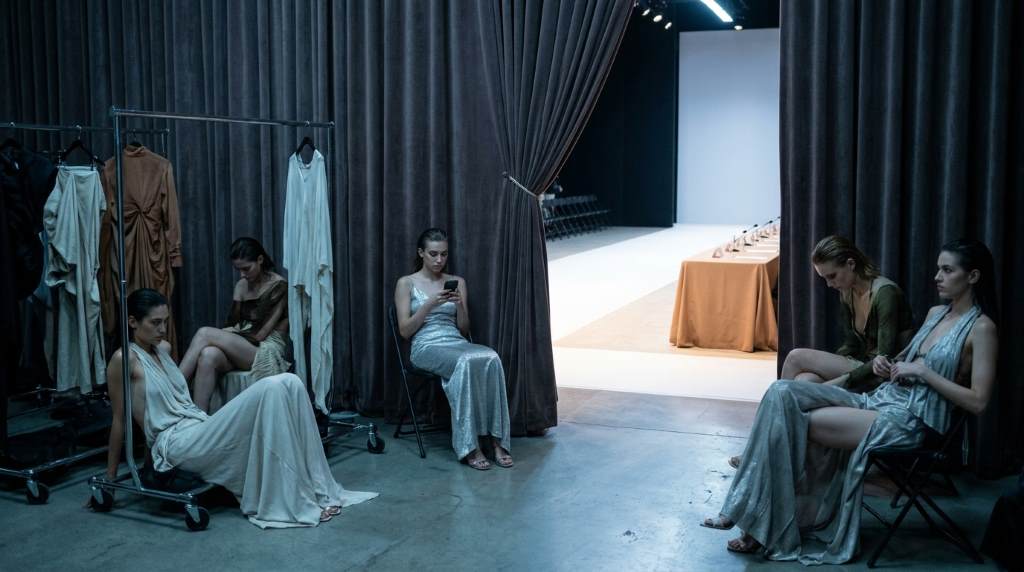 Fashion judges reviewing runway competition scores